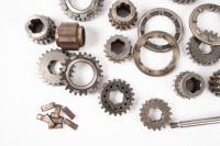 FT200: A group of Hewland FT200 gearbox parts, includes some possible unused cogs, selector forks, gears and other small gear set parts - 2
