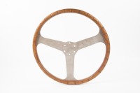 STEERING WHEEL: A wooden rimmed three spoke steering wheel, 38cm in diameter