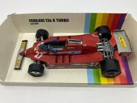 FERRARI 126K: A 1:24 scale model die-cast Burago 126K Turbo Formula One car, in original packaging [Location: Sydney]