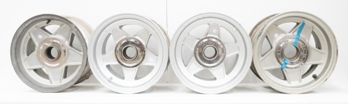 FERRARI WHEELS: Four Ferrari 365 alloy wheels with spinner plates and three hubs, includes two Cromodora 7.5" x 15" wheels (one has visible damage) and two non branded 8" x 15" wheels [Location: Melbourne]