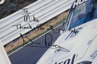BATHURST 1990: A large laminated Bathurst 1990 Poster 'The Lion Tames The Mountain - V8 & V6 Victories at Bathurst 90' personally signed and inscribed 'To Mike' by Win Percy, measures 140cm high, 97cm wide. - 5