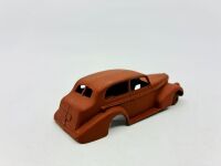 DINKY: Twelve unpainted car and truck bodies, believed to be Dinky. [Location: Sydney] - 23