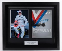 MICHAEL SCHUMACHER: A display piece containing a photo portrait of Michael Schumacher & signed program from the 2011 Formula One Korean Grand Prix, overall size 50.5cm high, 59.5cm wide