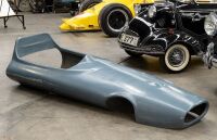 RACING CAR: A fibreglass cockpit surround/nose cone in the style of a 1960s open wheel racing car, 215cm long