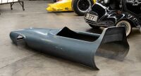 RACING CAR: A fibreglass cockpit surround/nose cone in the style of a 1960s open wheel racing car, 215cm long - 2