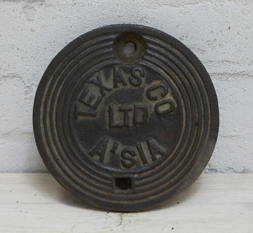 TEXAS CO: A service station underground tank filler cover plate, 'TEXAS CO LTD A'SIA' lettering inside 5 cast rings, 20cm diameter