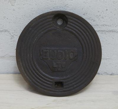 EUDIO: A cast iron service station underground tank filler cover plate - EUDIO LTD lettering in cast shape, 20cm diameter