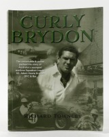 BRYDON: A soft cover book titled 'Curly Brydon' by Richard Townley, covering the story of Australia's youngest Squadron leader turned race car driver. Cover page inscribed and signed by author