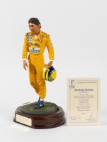 SENNA: A 1:9 scale limited edition (3948/5000) cold cast porcelain resin figure of Ayrton Senna sculpted by Paul Szeiler for Endurance Ltd, on a wooden base with engraved plaque, NIB and accompanied by a COA from The Art of Sport, 23cm high