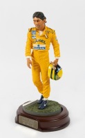 SENNA: A 1:9 scale limited edition (3948/5000) cold cast porcelain resin figure of Ayrton Senna sculpted by Paul Szeiler for Endurance Ltd, on a wooden base with engraved plaque, NIB and accompanied by a COA from The Art of Sport, 23cm high - 2