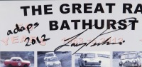 BATHURST: A framed and glazed poster by Autopics titled 'The Great Race - Bathurst - 50 Years - 1963-2012' signed and inscribed by Larry Perkins, measures 70.5cm high, 49cm wide. - 2