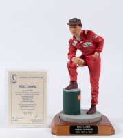 NIKI LAUDA: A 1:9 scale limited edition (971/2500) cold cast porcelain resin figure of Niki Lauda sculpted by Paul Szeiler for Endurance Ltd, on wooden base with engraved plaque, NIB and accompanied by a COA from The Art of Sport, 22cm high [Location: Mel