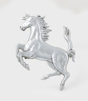 FERRARI: A pressed metal 'Cavallino Rampante' badge, 11cm high with two mounting pins [Location: Melbourne]
