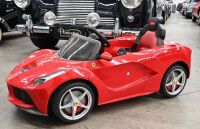 FERRARI: A Rastar childrens electric ride-on Ferrari car, with remote control option for parents, 1.2m long, 60cm wide [Location: Melbourne]