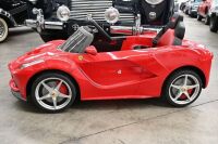 FERRARI: A Rastar childrens electric ride-on Ferrari car, with remote control option for parents, 1.2m long, 60cm wide [Location: Melbourne] - 2
