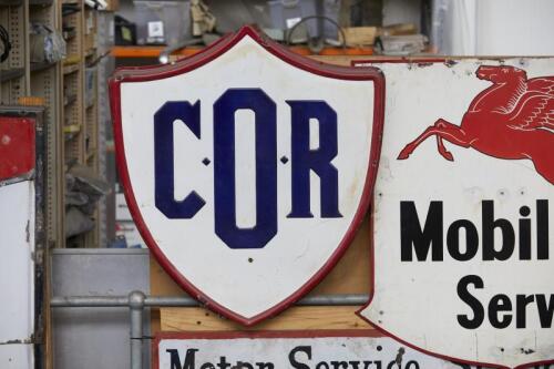 C.O.R: An embossed enamel shield shaped sign, 91cm high.