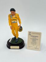 SENNA: A 1:9 scale limited edition (3945/5000) cold cast porcelain resin figure of Ayrton Senna sculpted by Paul Szeiler for Endurance Ltd, on a wooden base with engraved plaque, NIB and accompanied by a COA from The Art of Sport, 23cm high