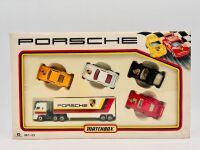 PORSCHE: A Matchbox Porsche Gift Set (MC-23) featuring a transporter and four 1:64 scale Porsche models, complete with original packaging [Location: Sydney]