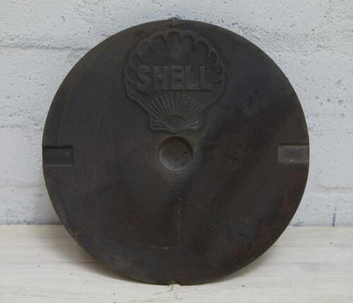 SHELL: A cast iron service station underground tank filler cover plate with SHELL lettering inside Shell Clam, 27cm diameter.