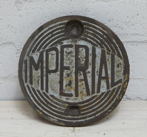 IMPERIAL: A cast iron service station underground tank filler cover plate with IMPERIAL lettering and diamond inside 6 cast rings pattern, 20cm diamater.