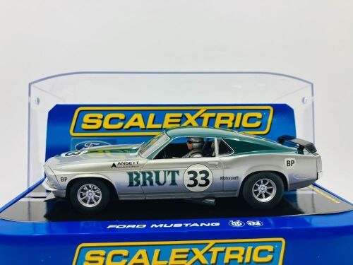 22 · ALLAN MOFFAT: A 1:32 Scalextric slot car of Allan Moffat's No. 33 Brut sponsored Ford Mustang, in original packaging together with a copy of his hardcover autobiography 'Allan Moffat: Climbing the Mountain' [Location: Sydney]
