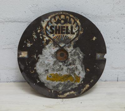 SHELL: A cast iron SHELL tank filler cover plate with small filigree style clam shell.