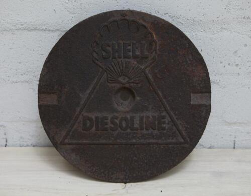 SHELL: A cast iron service station underground tank filler cover plate with SHELL lettering inside Shell Clam and "DIESOLINE" in matching block lettering, 27cm diameter.