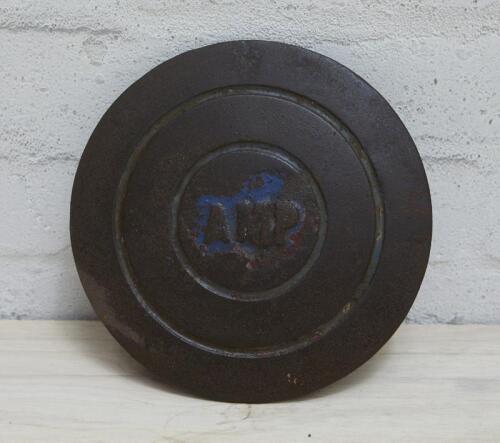 AMP: c1936-1949 cast iron service station underground tank filler cover plate with AMP lettering, 19.5cm diameter.