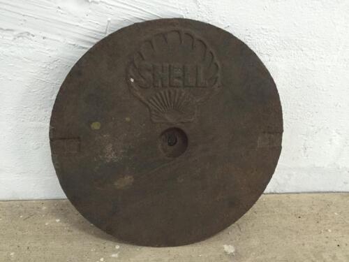 SHELL: A cast iron service station underground tank filler cover plate, Shell Clam with lettering inside shell, 27cm diameter.