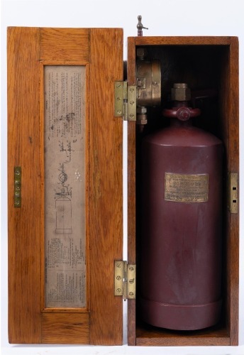ACETYLENE GENERATOR: A circa 1910s running board acetylene generator made by the Acetylene Illuminating Co. (England), presented in timber box, includes printed instructions, tank, gauge and handle, box 50cm long, 20cm high, 22cm deep