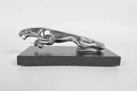 JAGUAR: A circa 1960s to 1980s Jaguar 'leaping Jaguar' mascot, to suit various models, 20cm long, affixed to timber base, broken tail piece