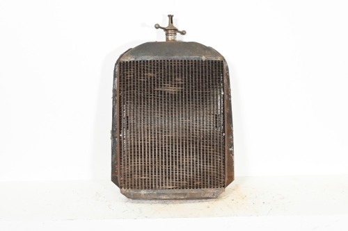 RADIATOR: A circa 1910s or 1920s US made radiator, includes the core and a 'dog-bone' (marked 'Beacon') cap, 87cm high, 57cm wide