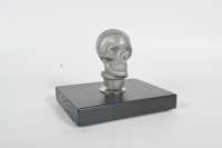 SKULL KNOB: An alloy human skull gear knob affixed to timber base, knob 7cm high