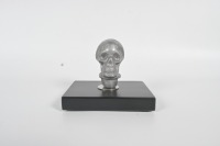 SKULL KNOB: An alloy human skull gear knob affixed to timber base, knob 7cm high - 2