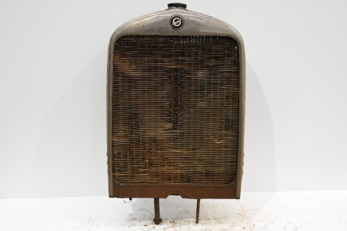 STUDEBAKER: A circa 1920s Studebaker radiator with core & surround, also with enamel badge, 77cm high, 54cm wide
