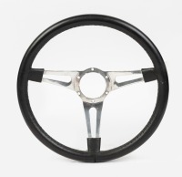 STEERING WHEEL: A three spoke leather rimmed steering wheel, US racing style, width 38cm