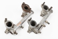 INTAKE MANIFOLDS: Two intake manifolds, marked 'AEH174', believed to suit MG MGA 1500 engine