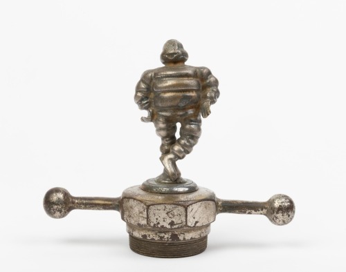 MICHELIN: A nice early nickel plated brass figural mascot of Monsieur Michelin Bibendum, figure 9.5cm high