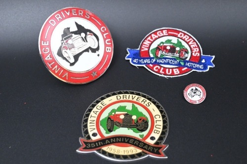 VINTAGE DRIVERS CLUB: A group of Vintage Drivers Club items, includes two grille badges, one small lapel pin and one cloth patch