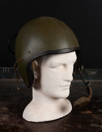 US MILITARY HELMET: A Vietnam war era combat vehicle crewman (CVC) helmet model, with headphones built in and adjustable microphone