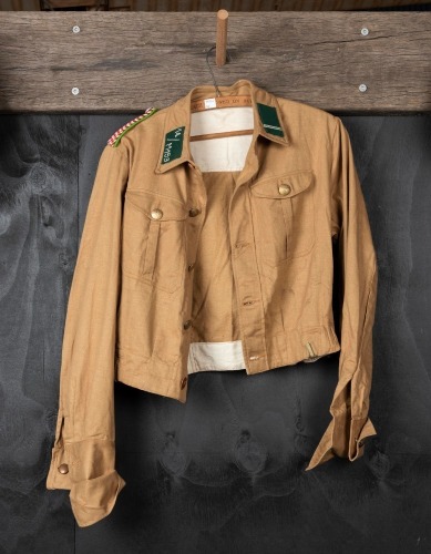 MILITARY JACKET: A German military blouse with red and white striped epaulettes and German WWII insignia buttons