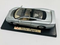 JAGUAR: A 1:18 scale model of the XJ220 by Maisto, mounted on plinth without original packaging together with a framed black and white photo of Kerry Manolas' XJ220 (K644 WJO) being unloaded, 33cm x 26cm - 3