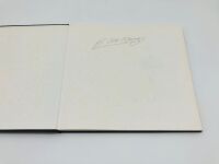 JUAN MANUEL FANGIO: A pair of hardcover books including "A Pirelli Album" by Stirling Moss signed by Fangio. - 4