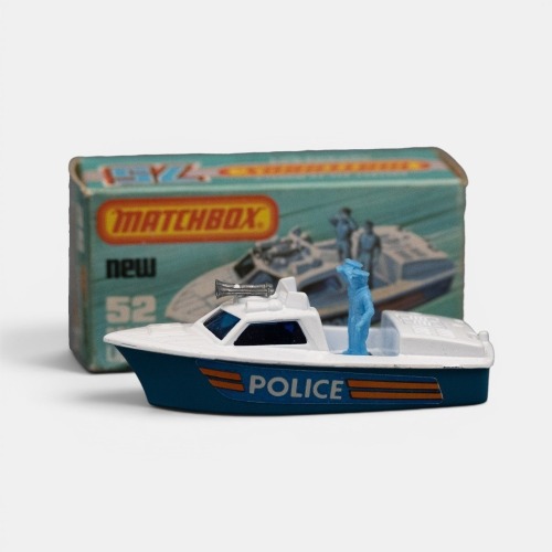 POLICE: A Matchbox 1-75 Police launch boat model, finished in white paintwork over a blue base, has all the Police decals still intact, both Police officers still on board, model number 52, made in England