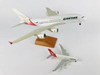 QANTAS AIRBUS A 380: 2 Models (longest 36cm): A 1:200 scale resin model registration 'VH-OQA' on stand with wheels and A 1:500 scale metal model on wheels, registration 'VH-OQA' - 2