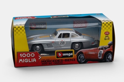 MERCEDES BENZ: A Bburago 1:24 scale 1954 Mercedes Benz 300 SL model, the number 259 race car in rally livery, finished in silver with yellow stripes paintwork with cream interior, part of the 1000 Miglia collection, model number 1222