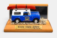 INTERNATIONAL: A 1961 International Scout 80 model, finished in the Mataura brown trout livery, this is a code 3 model, with the model mounted onto a customised wooden plinth, titled Koru Care 2000, limited edition number 6 of 15