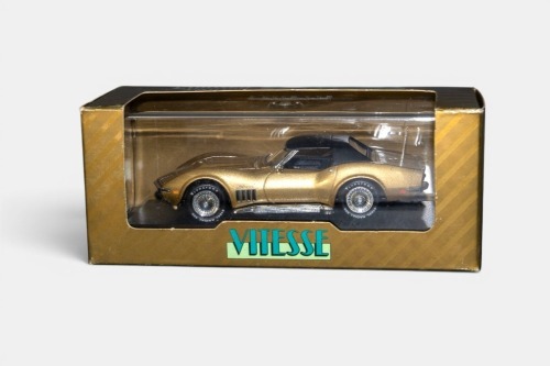 CORVETTE: A 1:43 scale Vitesse model, a 1969 Chevrolet Corvette coupe hard top, finished in gold paintwork with a black roof, model number L074 A