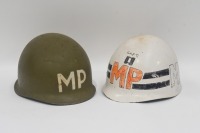 M1 HELMET: A 1950/60s US M1 Military Police helmet, with canvas and leather strapping to the interior, stamped with cross and US 14B