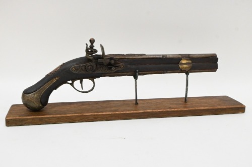 PISTOL: A reproduction flintlock pistol displayed on timber base, pistol 46cm long